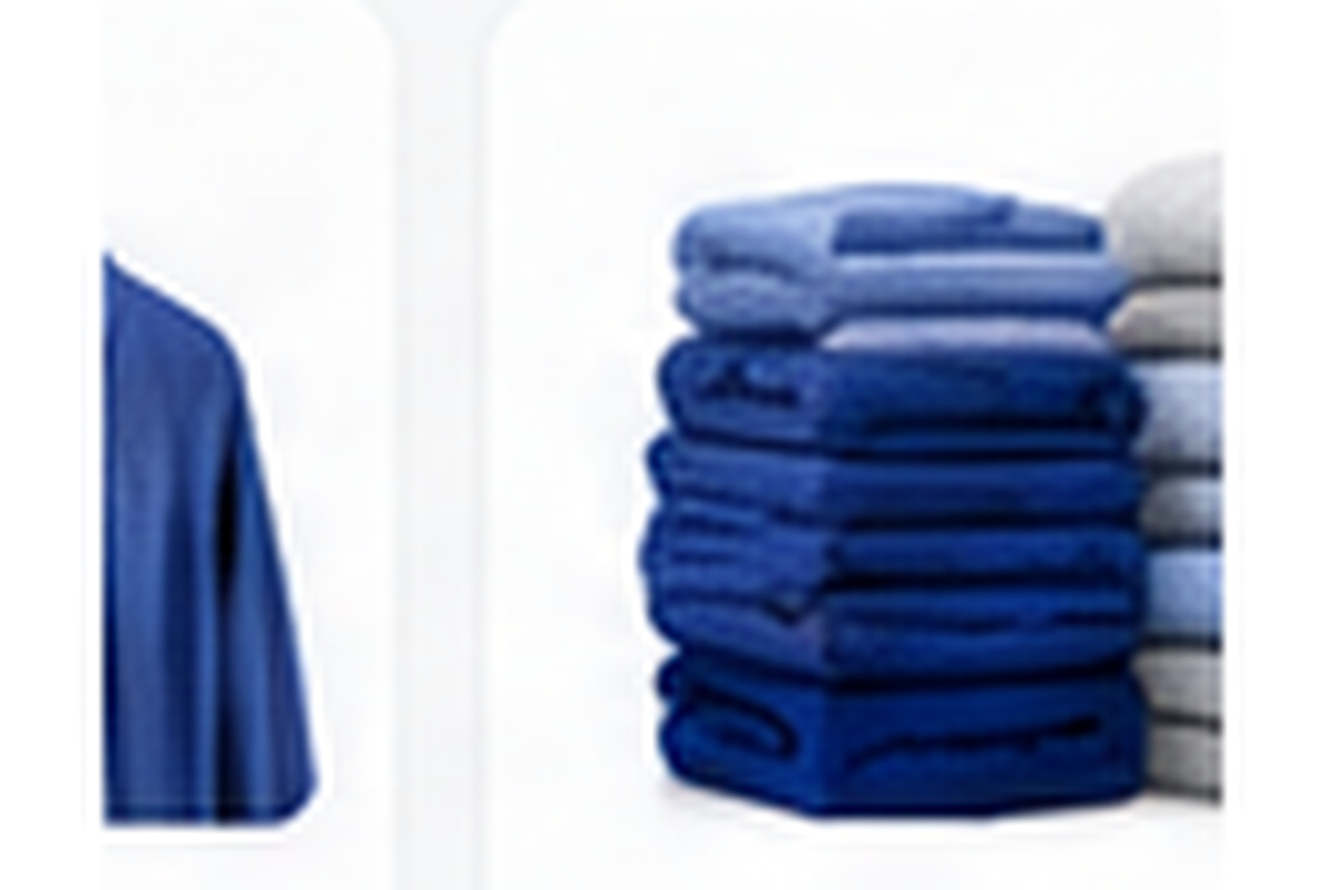 Neatly stacked clean linens representing bulky household laundry care