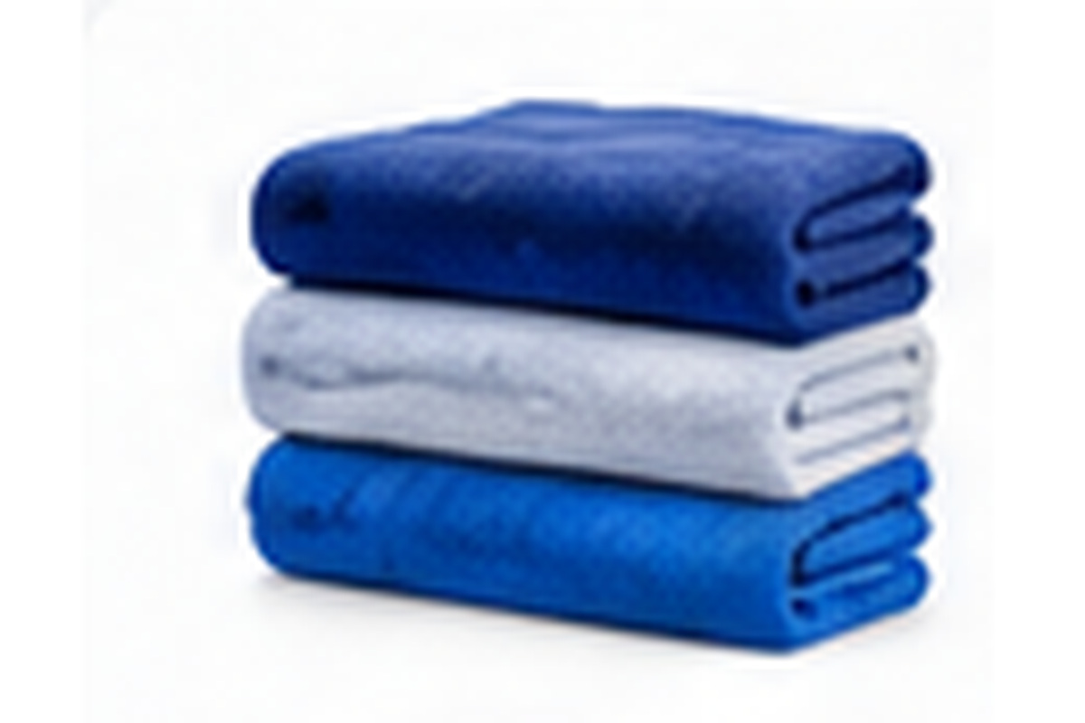 Freshly folded blue and white towels representing wash and fold service